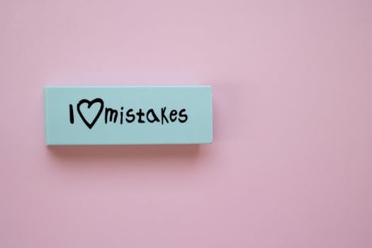 Minimalist eraser with 'I Love Mistakes' message on pink background, school stationery.